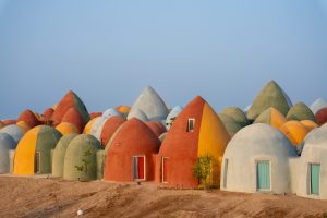 Majara Complex and Community Redevelopment, in Hormuz Island by ZAV Architects / Mohamadreza Ghodousi is famous for its colourful domes which provide sustainable accommodations for tourists who visit the unique landscape of Hormuz. Built by upskilled local workers, it also offers new facilities for the islanders who come there to socialise, pray, or use the library.